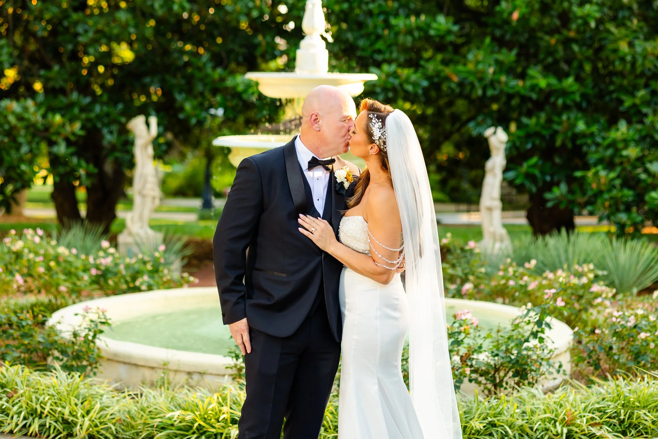 Couple kissing beside the fountain in the gardens at Belmont Mansion — Nashville, TN